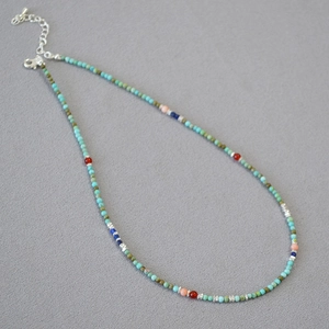 Detail of bohemian turquoise beaded necklace showing colorful beads and adjustable chain