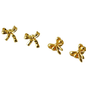 Polished gold-plated brass bow earrings with 925 silver needles on white background