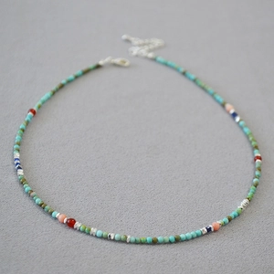 Bohemian turquoise beaded necklace with colorful stone accents and silver clasp