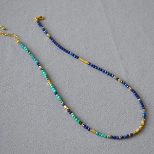 Detailed macro shot of handcrafted Lapis Lazuli and Turquoise beaded necklace textures