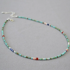 Detail of bohemian turquoise beaded necklace with colorful stones and lobster clasp
