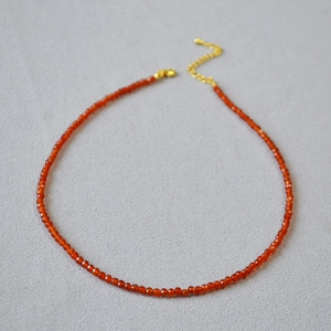 Minimalist red agate beaded necklace with faceted gemstones and golden lobster clasp