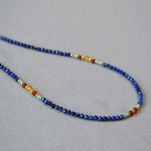 Handmade beaded necklace with lapis lazuli, red agate, turquoise, and gold spacer beads