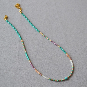 Colorful beaded necklace with turquoise and purple beads and adjustable gold clasp