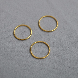 Three-piece set of minimalist gold rings with hammered texture for a layered fashion look