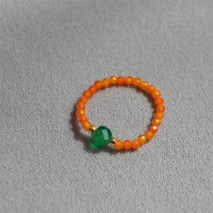 Detail of colorful faceted beads and green sugar cube bead on a handcrafted ring