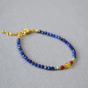 Detail of natural lapis lazuli necklace with red agate, turquoise and golden beads