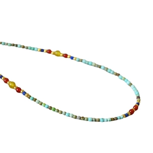 Ethnic style necklace with colorful turquoise, red agate and yellow beads on white base