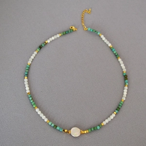 Ethnic beaded necklace with turquoise stones, freshwater pearls and gold metal spacers