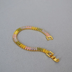 Gold-plated brass bracelet featuring gradient rectangular colorful cubic zirconia stones