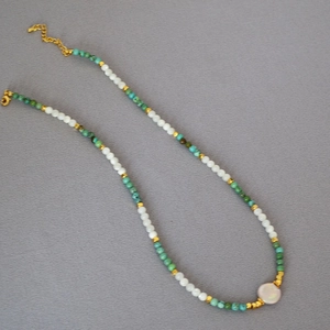Beaded necklace with turquoise stones, freshwater pearls and golden lobster clasp