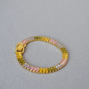 Detail of gold plated brass bracelet featuring colorful rectangular zircon stones and clasp