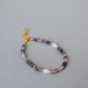 Detail of purple natural stone and freshwater pearl beaded bracelet with lobster clasp