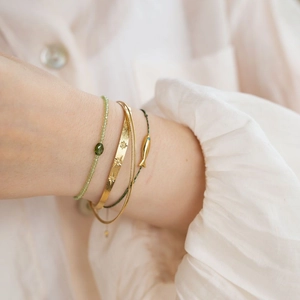 Olive green zircon beaded bracelets set with gold star-patterned bangle and fish charm