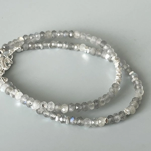 Macro view of gray faceted labradorite beads with silver accents and lobster clasp