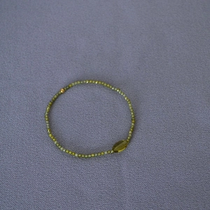 Olive green zircon beaded stretch bracelet with marquise stone and golden accent bead
