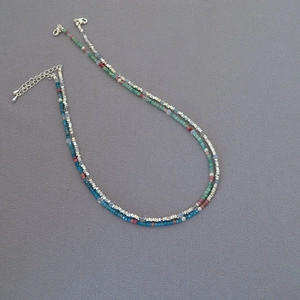 Detail of colorful beaded necklaces with silver accents and secure lobster clasp closure