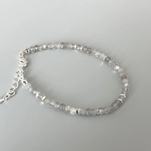 Detail of grey moonstone faceted beads bracelet with silver spacers and lobster clasp closure