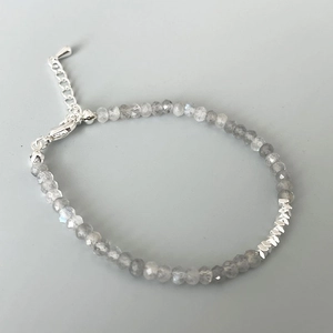 Detail of faceted grey moonstone beaded bracelet with silver lobster clasp and chain