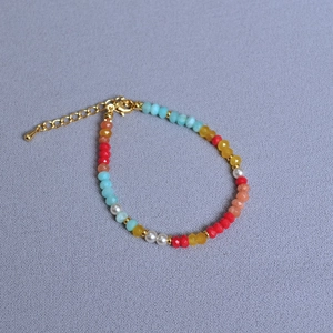 Detail view of colorful Amazonite beads and white pearls with gold adjustable chain clasp