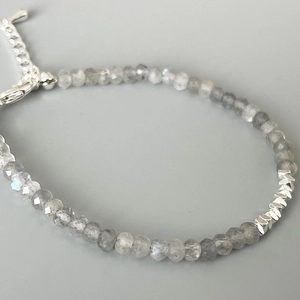 Macro shot of faceted grey moonstone beads and silver-tone accents on a chic bracelet