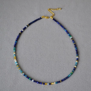Detail of beaded necklace with lapis lazuli, pearls, and adjustable gold lobster clasp
