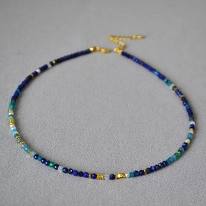 Detailed macro view of Van Gogh starry sky lapis lazuli beaded necklace with gold spacers
