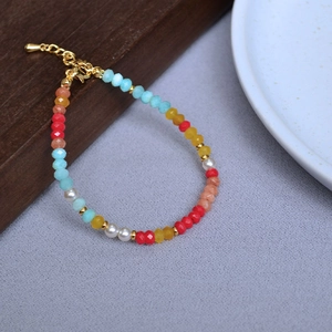 Macro shot of colorful faceted beads and golden lobster clasp on a summer style bracelet