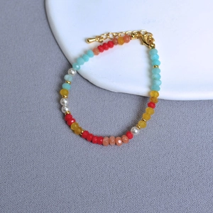 Detail of colorful faceted crystal beads and white pearls with golden lobster clasp