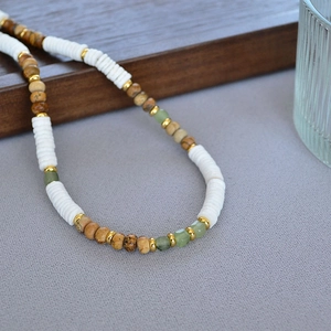 Close-up of bohemian beaded necklace with white heishi shells and turquoise stones
