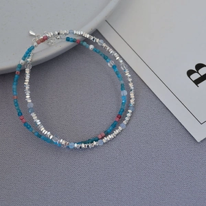 Macro detail of French retro beaded necklaces with blue stones and silver accents