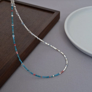 Detailed macro view of French vintage beaded necklace with pearls and silver chain accents