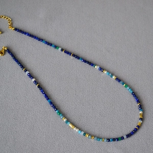 Detailed macro view of lapis lazuli beads with gold hexagon spacers and lobster clasp