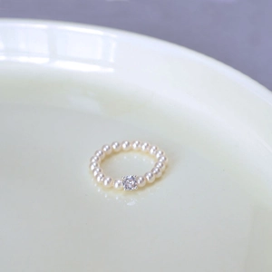 Detailed macro view of the pearl ring with a sparkling crystal centerpiece