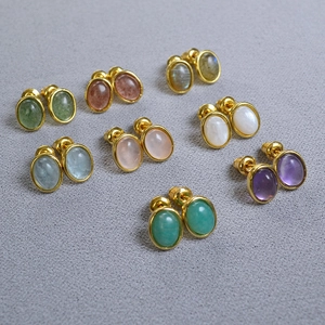 Eight pairs of oval natural stone earrings in various colors with gold plated settings