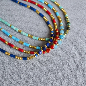Detail view of Bohemian multi-layer beads and faceted stones with gold accents