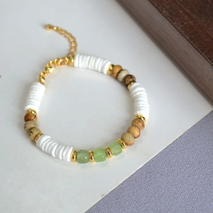 Detail of beaded holiday style necklace with white shells and natural stone beads
