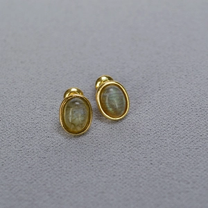 Detail shot of oval labradorite gemstone stud earrings with a gold-plated brass frame