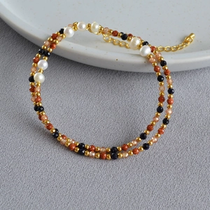 Detail of baroque pearl bracelet with gold beads and blue sandstone in dual-layer design