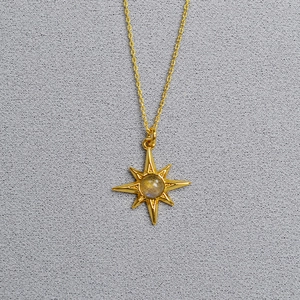 Detailed macro view of gold-plated brass octagram pendant with blue labradorite stone