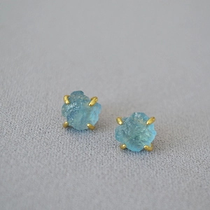 Luxurious gold-plated brass stud earrings with irregular raw aquamarine in four-prong setting