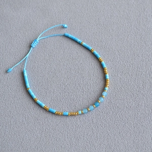 Close-up of bohemian blue bead bracelet with natural stones and adjustable cord