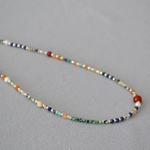 Close-up of lapis lazuli, turquoise, and freshwater pearls on a beaded necklace