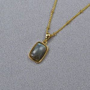 Detail of gold-plated brass necklace featuring a rectangular labradorite stone pendant
