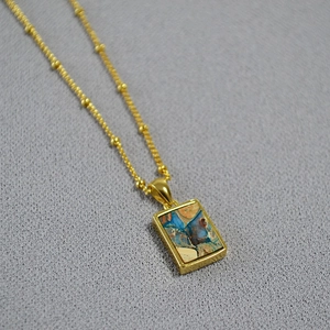 Vintage golden necklace with geometric rectangle pendant featuring colorful marble stone