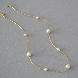 Elegant gold snake chain necklace with white pearls of various sizes for women