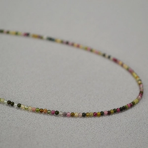Macro shot of colorful 2mm natural tourmaline stone beads for elegant necklaces