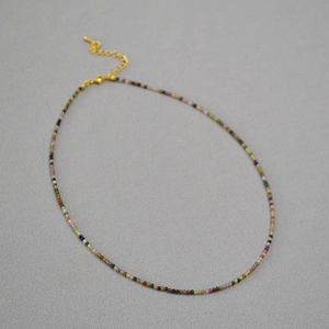 Macro detail of 2mm colorful tourmaline bead necklace with golden adjustable clasp