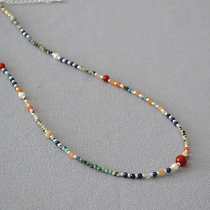 Detail of beaded necklace featuring lapis, turquoise, pearls and silver lobster clasp