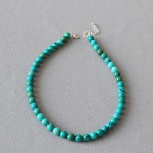 Close-up of turquoise beaded necklace with silver lobster clasp and extension chain